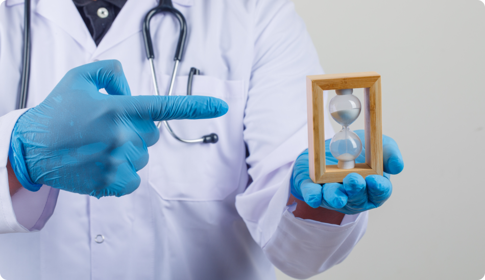Doctor holding and pointing at hourglass